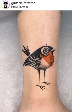 a small bird tattoo on the ankle with an orange and black stripe around its head