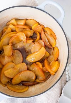 a pot filled with sliced apples on top of a table