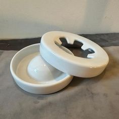 two white bowls sitting next to each other