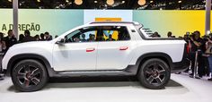 a white truck is on display at an auto show