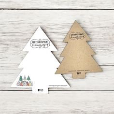 two wooden christmas trees are shown on a white wood background with the words merry christmas written in