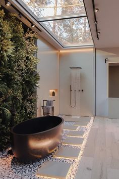 a bath tub sitting under a skylight in a bathroom