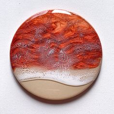 a red and white plate sitting on top of a white table next to a wall