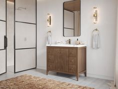 a bathroom with two sinks, mirrors and a rug on the floor in front of it