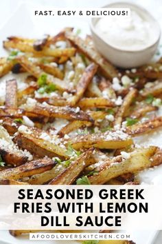 seasoned greek fries with lemon and dill sauce on a white platter, with text overlay