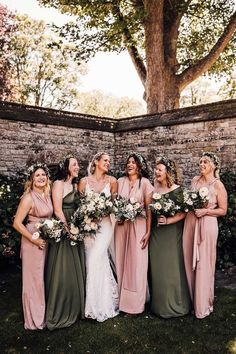 Bridal party shot with bride in boho lace wedding dress with bridesmaids in pink and green dresses with flower crowns Bridesmaid Dresses Sage Green And Blush, Dark Green And Pink Bridesmaid Dresses, Pink Green Bridesmaid Dresses, Sage Green Dusty Blue Blush Pink Bridesmaid Dresses, Green And Blush Bridesmaid Dresses, Sage Green And Blush Pink Bridesmaid Dresses, Wedding Colors Pink And Green, Dusty Pink And Emerald Green Wedding, Sage And Pink Bridesmaid Dresses