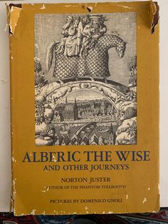 an old book is sitting on top of a carpeted surface with the title'alberic the wise and other journeys '