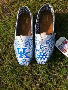 a pair of shoes sitting on top of a green grass covered field next to a magazine