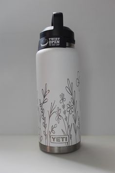 a white yeti water bottle sitting on top of a table