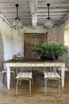 a dining room table with chairs and a potted plant on top of the table