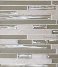 a close up view of a white and gray tile backsplash with silver foil