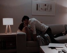 a man and woman kissing on the couch