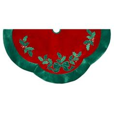 a red and green pot holder with holly leaves on it