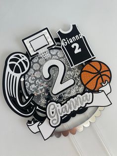 there is a basketball themed cake topper with the number two on it's side