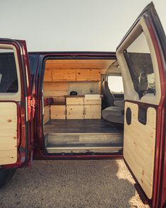 the back end of a red truck with its doors open and boxes in the trunk