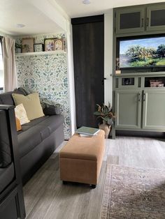 a living room filled with furniture and a flat screen tv mounted to the side of a wall