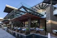 an outdoor dining area with tables and chairs