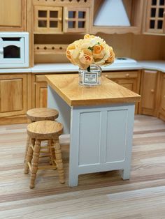 a model kitchen with stools and an island in front of the stove top oven