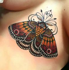 a butterfly tattoo on the back of a woman's stomach, with an intricate design