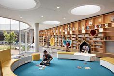 the children's library is equipped with bookshelves and seating for youngsters