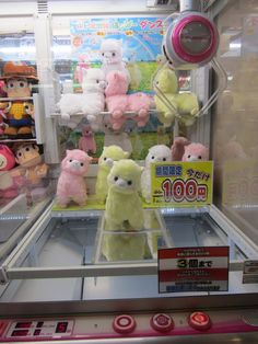 several stuffed animals are on display in a toy store's glass case for sale