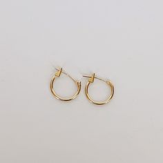 Add a touch of elegance to your everyday look with our 10k yellow solid gold huggie earrings. These timeless earrings are crafted to hug your earlobe comfortably and securely, making them perfect for everyday wear. And, with their simple yet stylish design, they're the ideal foundation for adding your favorite charms to create a personalized look that's uniquely yours. Try adding our Medusa Pendant for an edgy drop earring style. Details Crafted in solid 10k yellow gold for strength, comfort, an Medusa Pendant, Timeless Earrings, Gold Huggie Earrings, Ancient Persian, Persian Motifs, Huggie Earrings, Single Earring, Drop Earring, Huggies Earrings