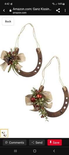 two christmas wreaths hanging from horseshoes with bows and decorations on the ends,