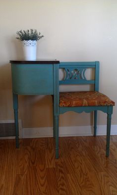 a blue desk and chair with a plant on top