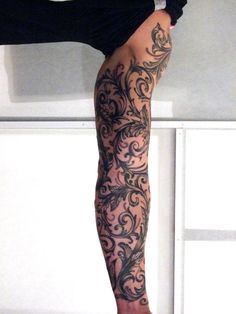 a woman's legs with tattoos on them and one leg in the shape of a flower