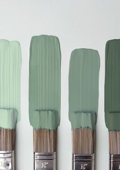 three paintbrushes with different shades of green