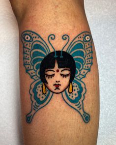 a woman's leg with a butterfly tattoo on it