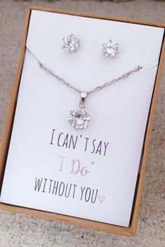 a necklace and earring set sitting in a box with a card saying i can't say i do without you