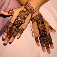 two hands that have hendi designs on them