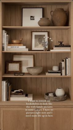 a book shelf with books and pictures on it