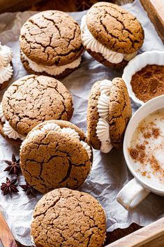 several cookies and cupcakes on a tray with cinnamon sprinkles next to them