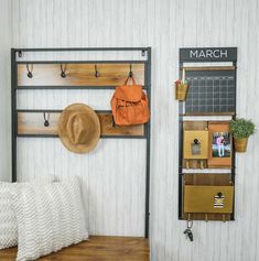 a room with a bed, hat rack and coat rack on the wall next to it