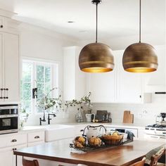 two lights hanging over a kitchen island