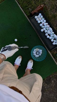 a person with white tennis shoes standing in front of some eggs on a green mat