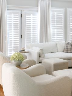 a living room filled with furniture and white walls