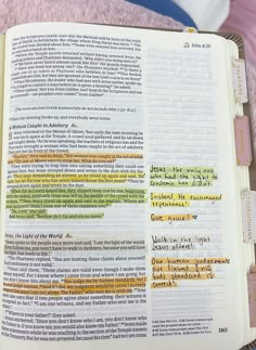 an open bible with colorful writing on it