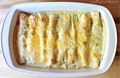 a casserole dish with cheese and meat in it on a wooden table top