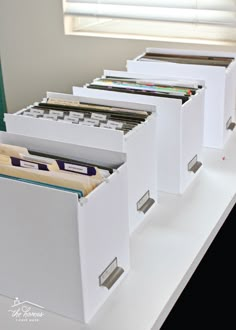 several file folders are lined up on a shelf