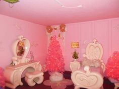 a room with pink walls and furniture in the corner, decorated for christmas or new year's eve