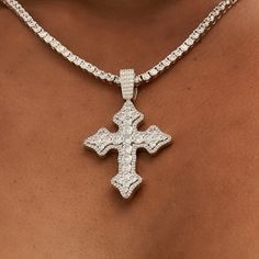 Introducing the Iced Gothic Cross in White Gold - a stunning addition to your pendant collection. Crafted with a durable 14k White Gold finish and hand-set stones, this cross is guaranteed to make a statement! Pair this piece with our 3mm Tennis Necklace in White Gold for a complete, elevated look. This product is guaranteed for life - GLD will repair the item should you experience any defects in craftsmanship or breakage. Specifications - 35mm x 42mm (Width x Height) - Bail: Fits up to 5mm Tenn