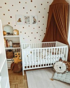 a baby's room with polka dot wallpaper and white crib