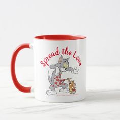 a red and white coffee mug with the words spread the love on it's side