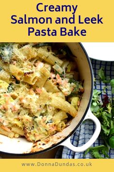 creamy salmon and leek pasta bake in a white pan on a blue checkered cloth