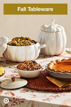 a table topped with white pumpkins and dishes filled with different types of food next to each other