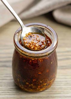 a spoon in a jar filled with food