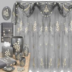 the bathroom is decorated in gray and white colors with gold flowers on the shower curtain